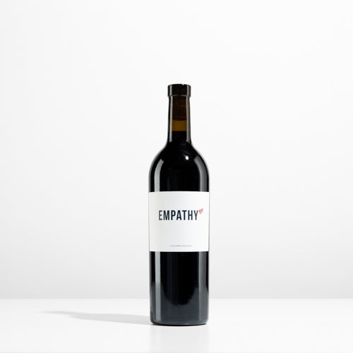 A bottle of EMPATHY RED on a light gray background
